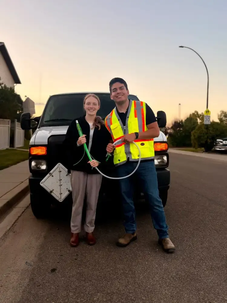 Allan and Rachel, the owners of GoFlow Services, with their cleaning equipment and service van