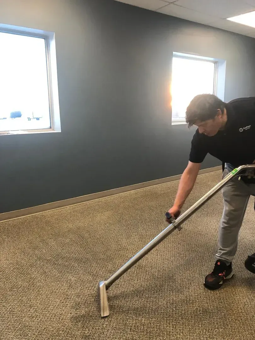 GoFlow technician making a cleaning pass across a carpet