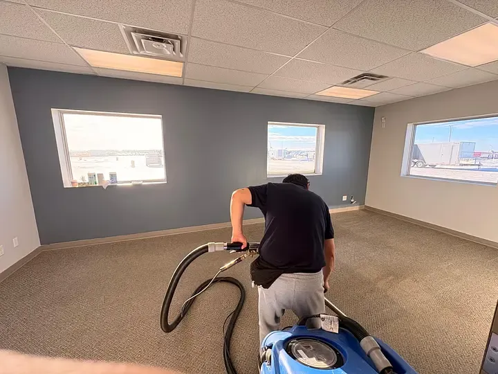 GoFlow team cleaning carpet in a commercial office