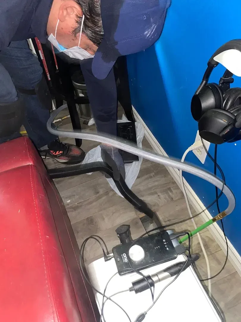 GoFlow technician using cleaning hoses and equipment indoors