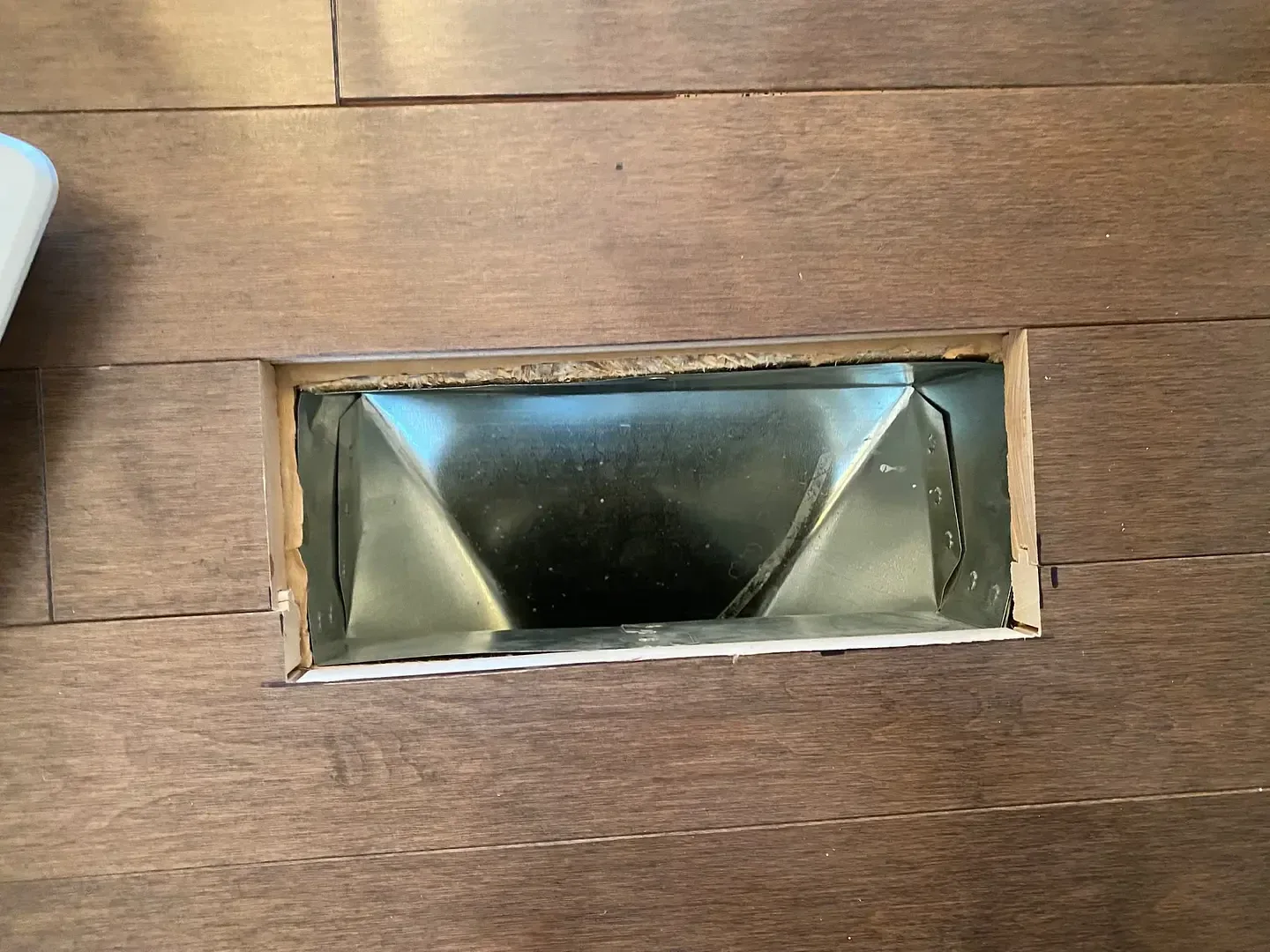 Metal floor register opening after cleaning