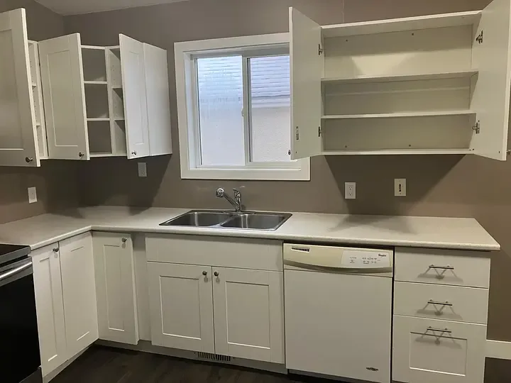 Kitchen with open cupboards during a GoFlow house-cleaning job