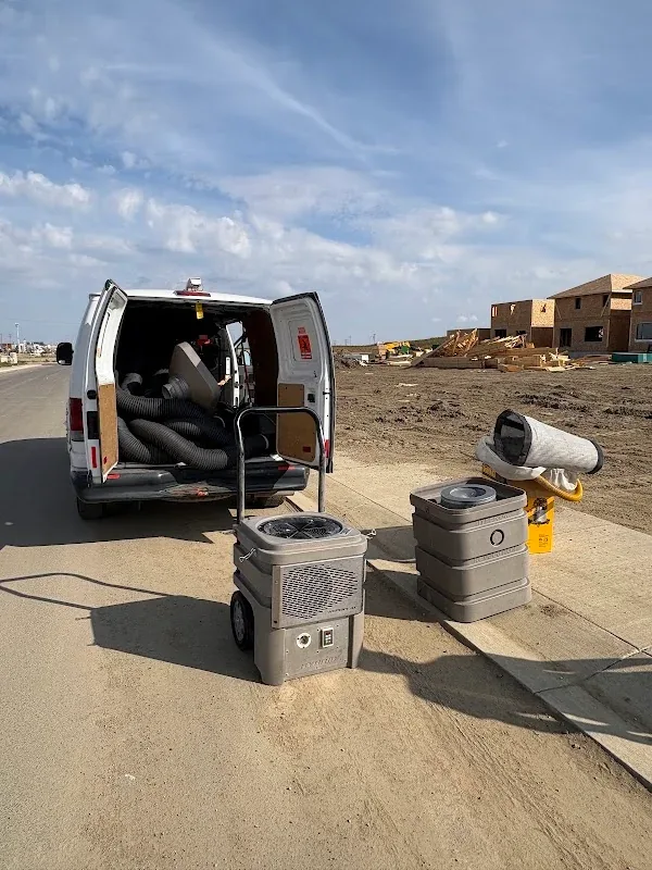 GoFlow van and cleaning equipment set up beside homes under construction