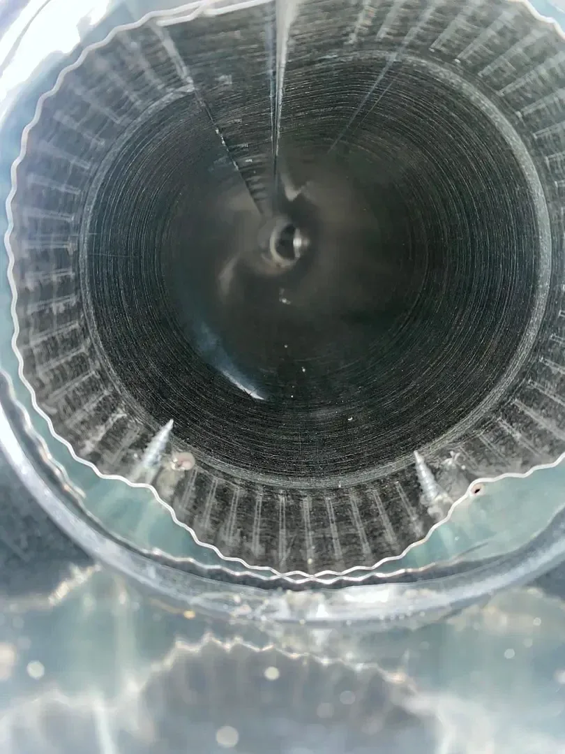 Looking into the interior of a round metal air duct