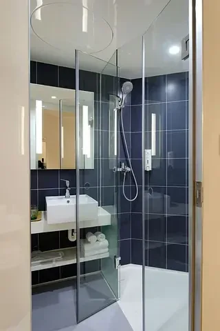 Glass shower enclosure and bathroom from GoFlow’s residential cleaning work